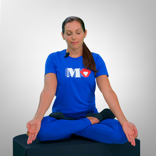 Fitness trainer demonstrating seated meditation